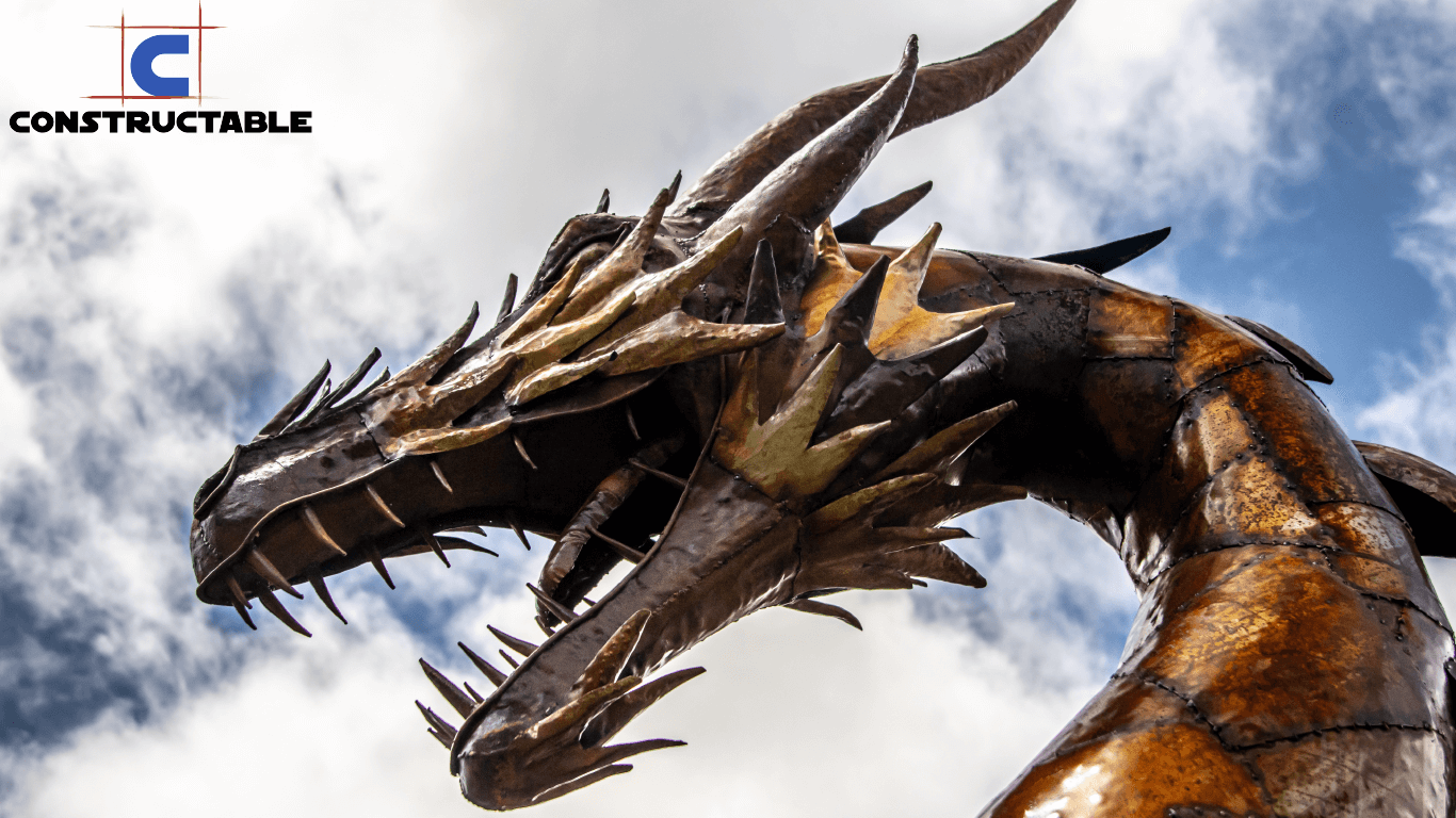 A dramatic close-up of a large metallic dragon sculpture with sharp teeth and scales, set against a cloudy sky. The structure appears dynamic and formidable, reflecting significant construction costs, and is enhanced by a vivid