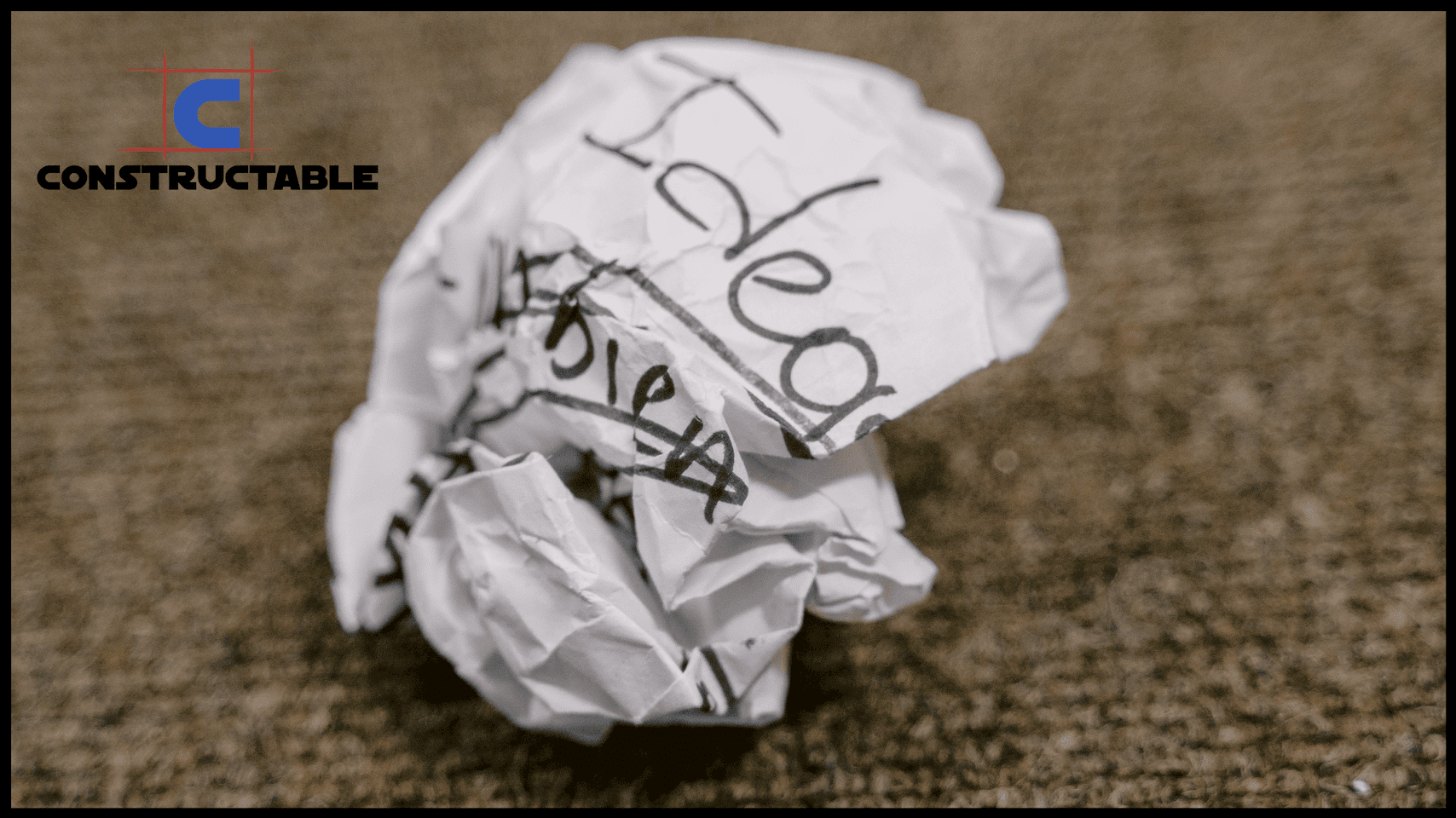 A crumpled piece of paper with the word "ideas" written on it lies on a carpeted floor, symbolizing discarded or rejected thoughts. The logo "Constructable" is visible in the